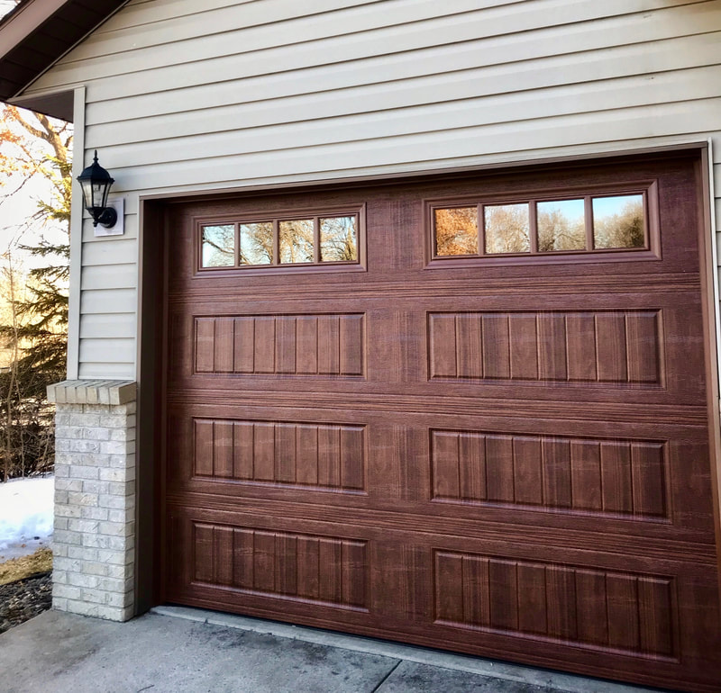 Amarr Designer's Choice Garage Door in Walnut with LP BB Panels and Thames Windows.  Installed by Augusta Garage Door in St. Cloud, MN.