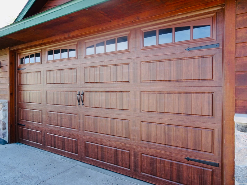 Amarr Hillcrest 3000 Garage Door in Walnut with Long Panel Bead Board and Arched Thames Windows.  Installed by Augusta Garage Door in Sartell, MN.